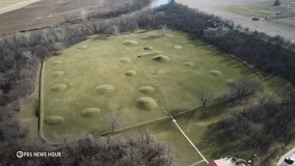 Aerial photograph of Mound City in Ohio, showing dozens of rounded burial mounds arranged within a rectangular earthwork enclosure built by the Hopewell Culture over 2,000 years ago.